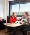 saleswoman speaking with a client in her office